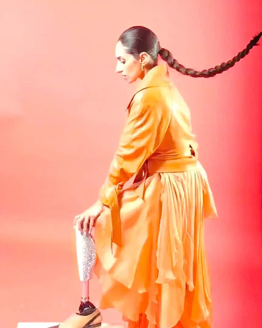 Thumbnail of Zainab at a photoshoot wearing an orange dress