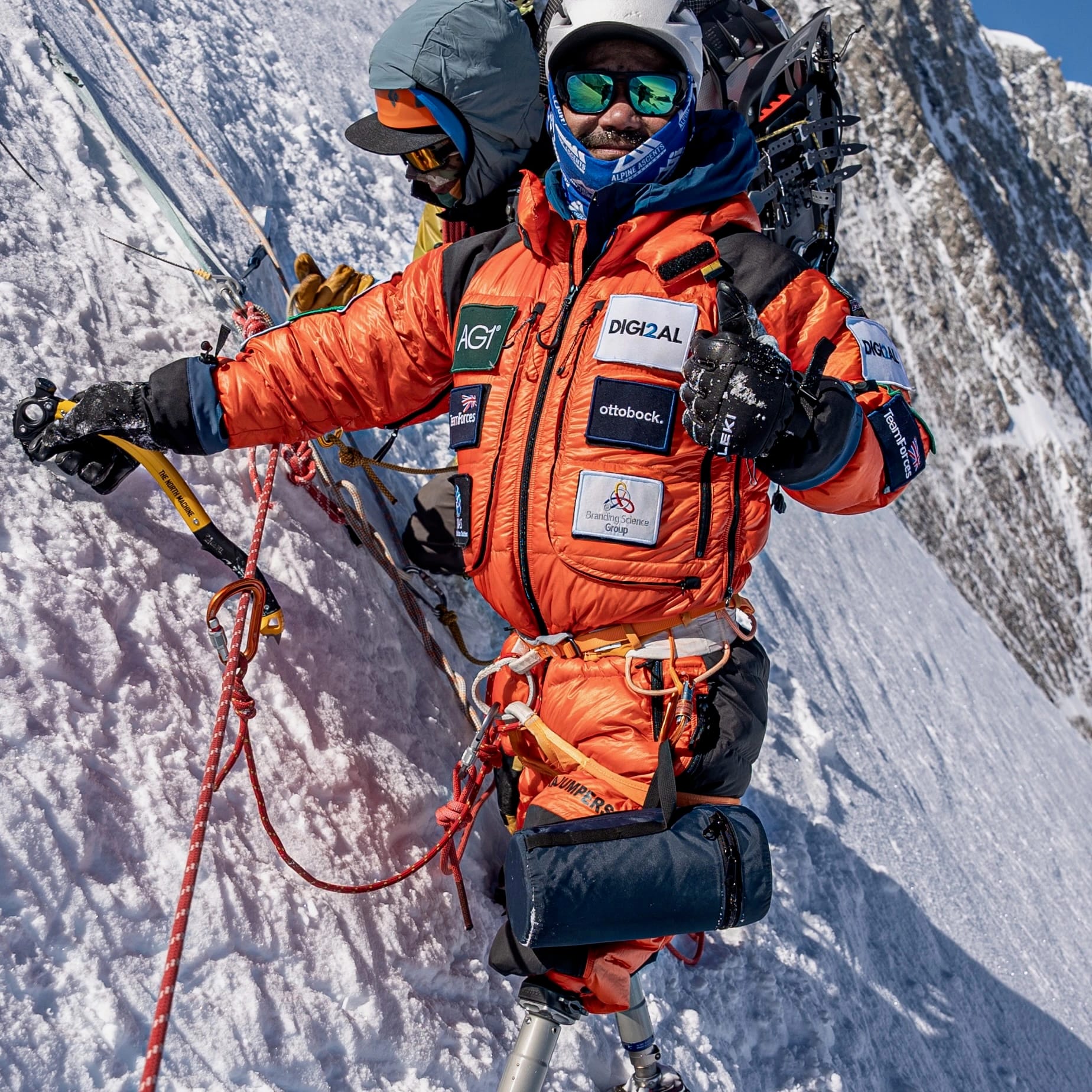 Hari climbing on a mountain and giving a thumbs up
